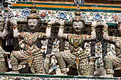 Bangkok Wat Arun - the distinctive decorations and the statues of the mythical  demon bears  that support the different levels of the prang.